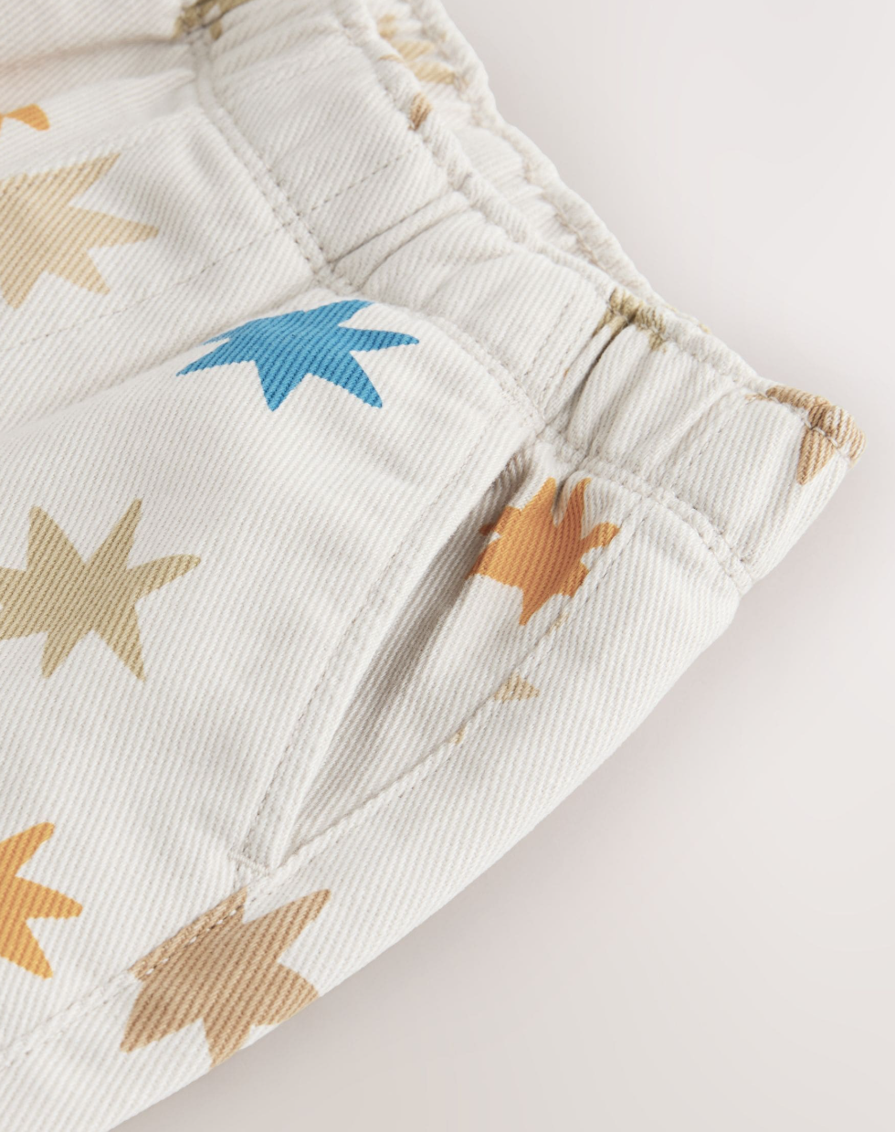 Pantalón crema con estrellas multicolor